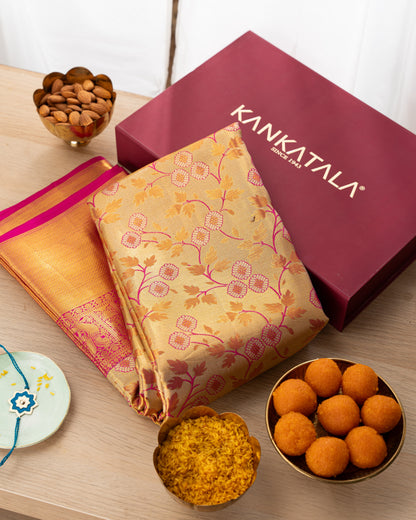 Taranga Kanchi Silk Jaal Tissue Gold Saree With Rakhi and Gift Box
