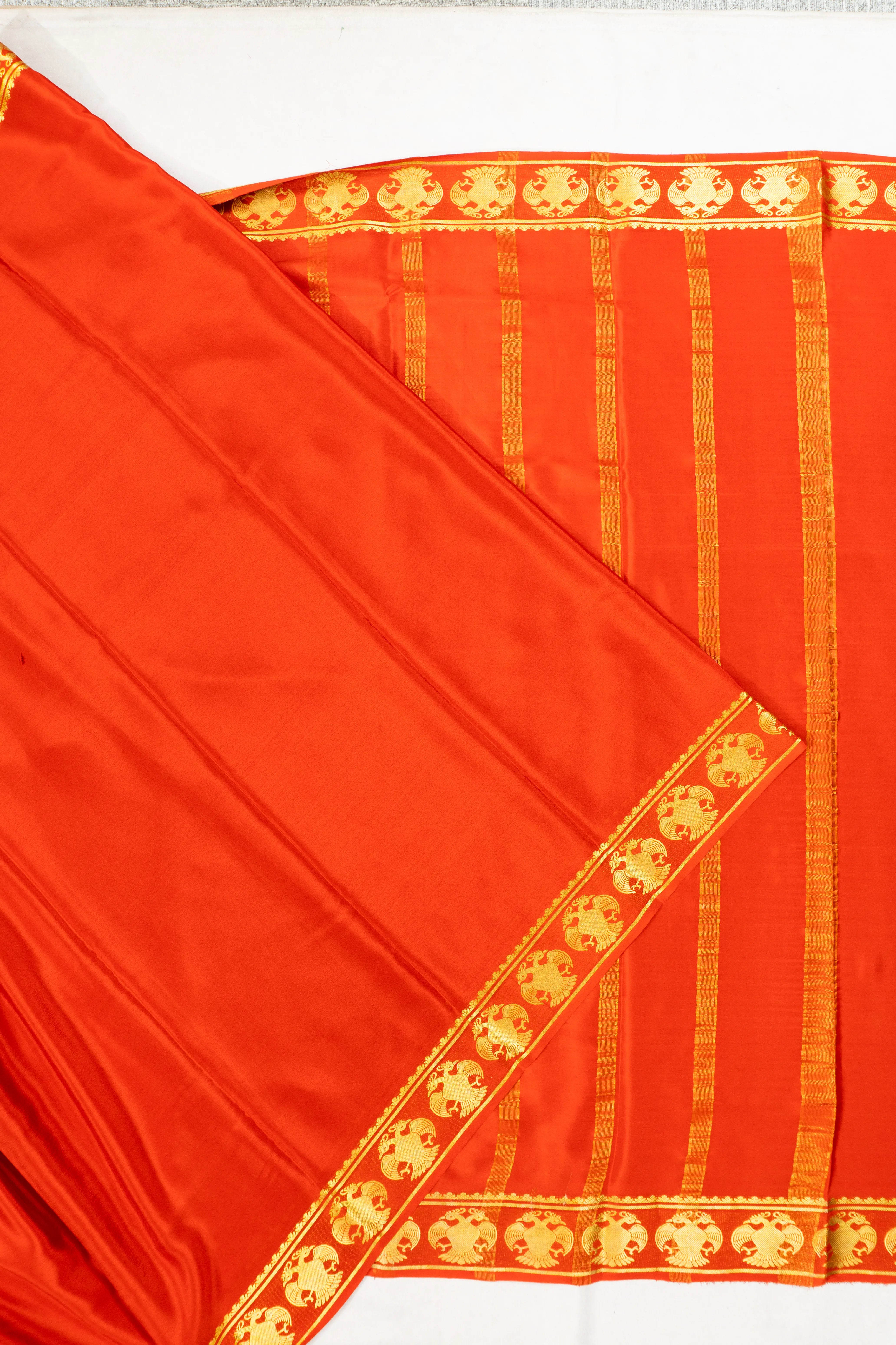Binny Silk Plain Orange Saree With Gandabherunda Border