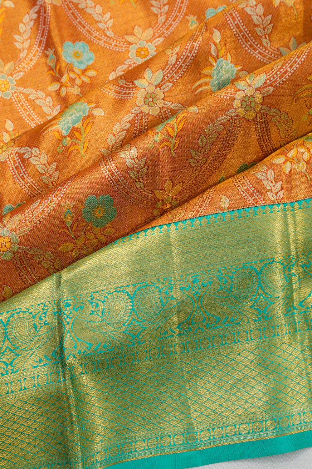 Taranga Kanchi Silk Jaal And Butta Orange Saree