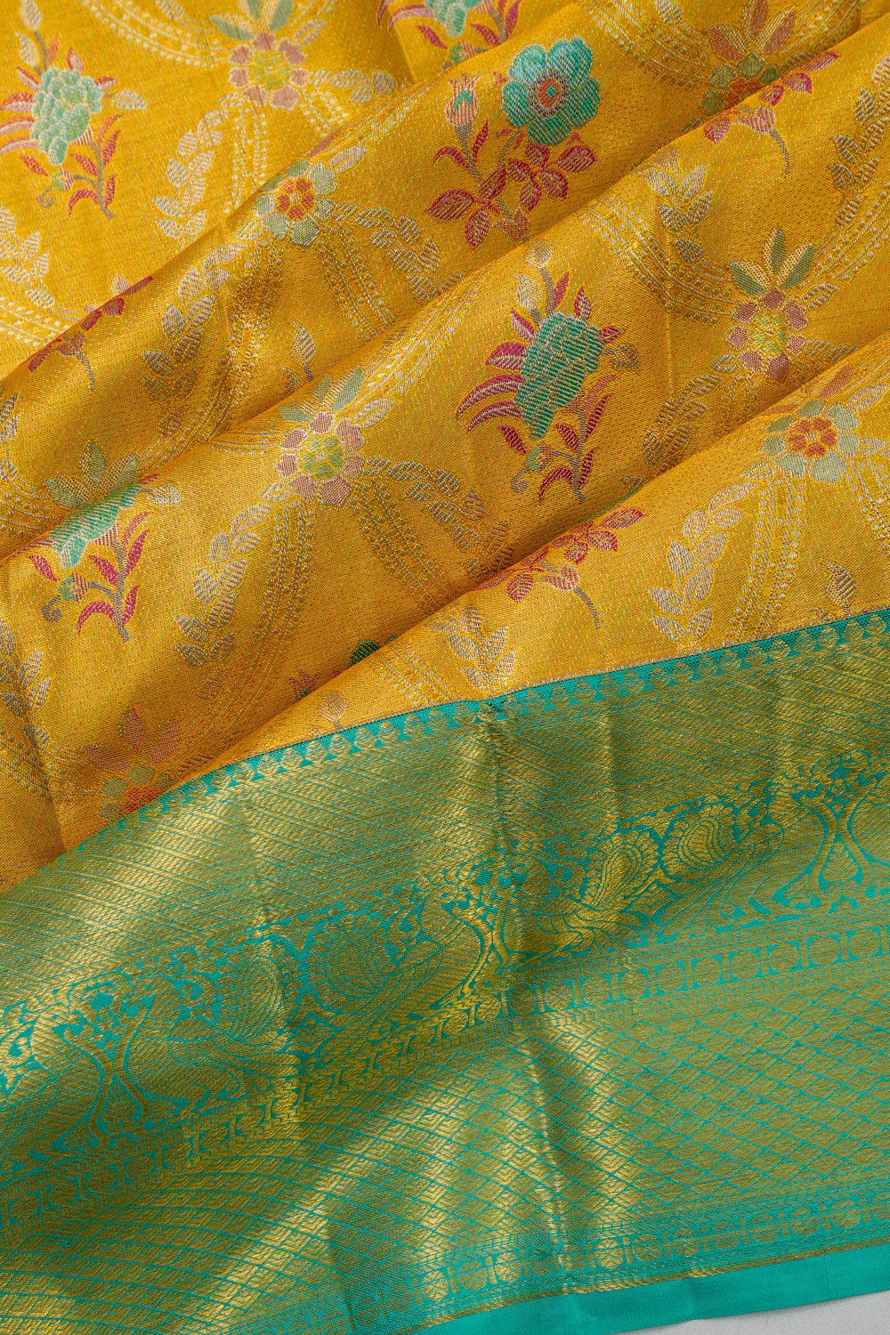 Taranga Kanchi Silk Jaal And Butta Orange Saree
