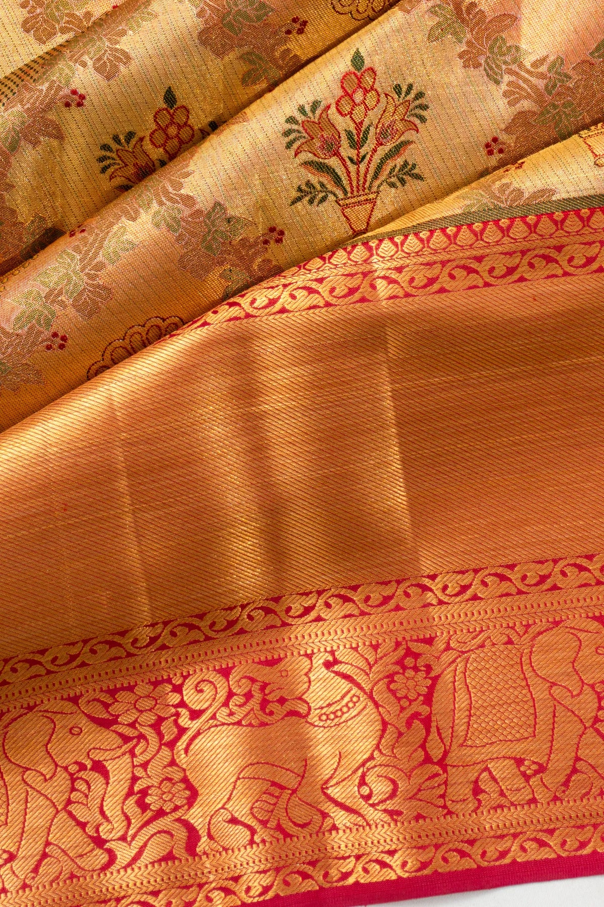 Taranga Kanchi Silk Tissue Jaal And Butta Gold Saree