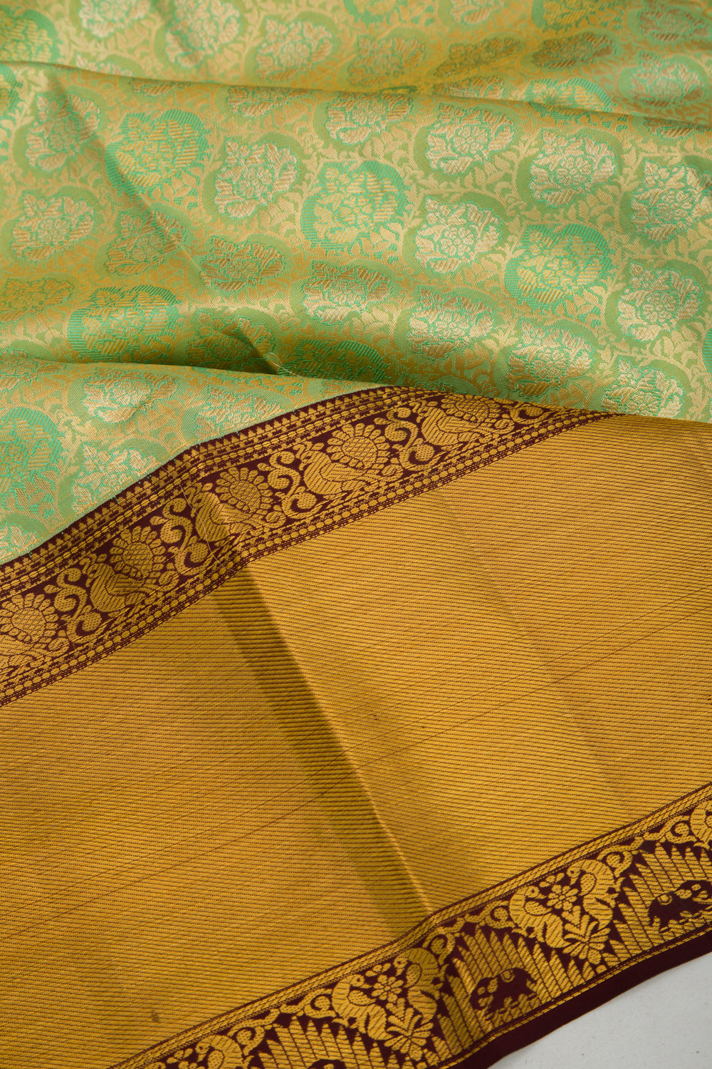 Taranga Kanchi Silk Tissue Brocade Green Saree