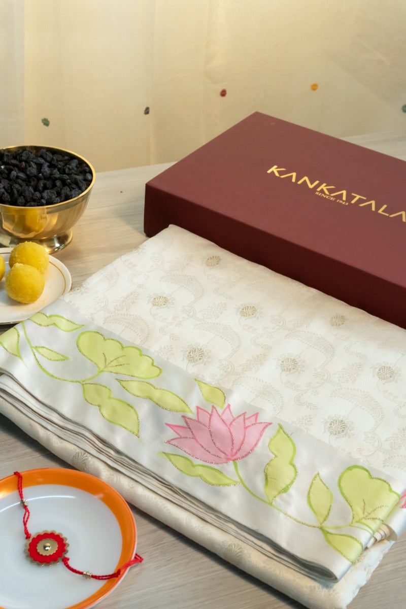Soft Tussar Jacquard And Butta Cream Saree With Floral Printed Satin Border With Gift Box And Rakhi